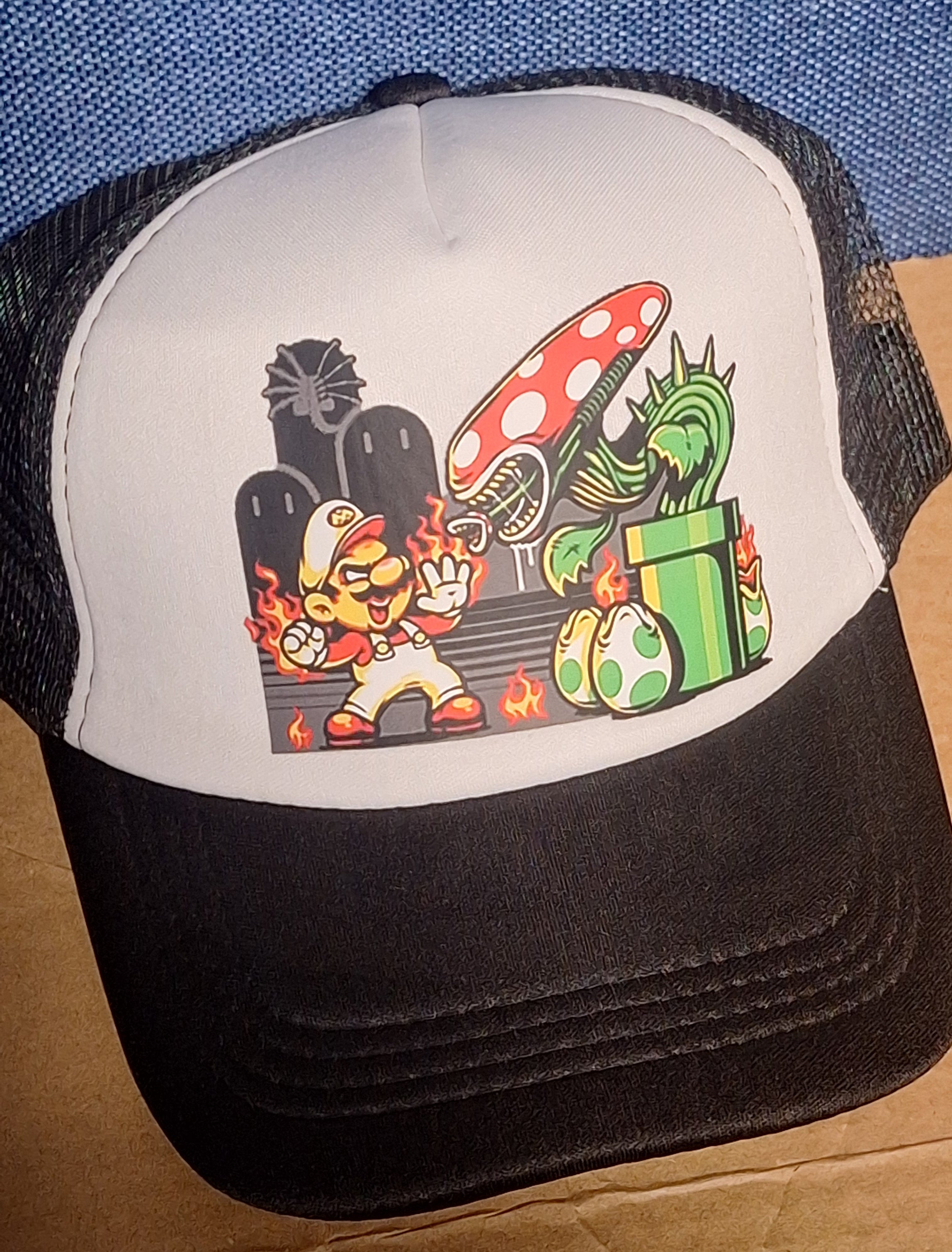 Adjustable Trucker Baseball Cap Featuring Fire Mario Versus Xenomorph and Piranha Plant Artwork